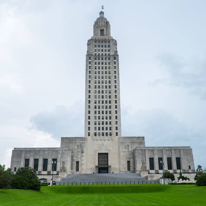 Louisiana State Capitol building in Baton Rouge under a blue sky.