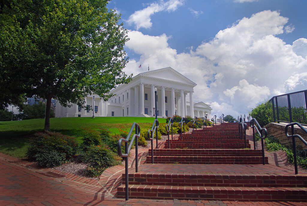 Virginia State Capitol building in Richmond with a walkway leading toward its entrance.